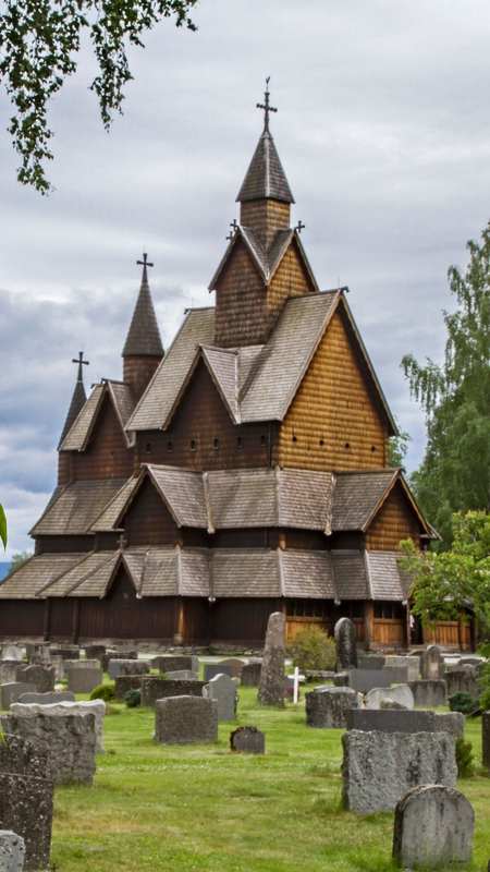 Heddal Stave Church, Eastern Norway — Norway's largest stave church from the 13th century, featuring a distinctive triple nave design with steep tiered roof and elaborate woodwork.